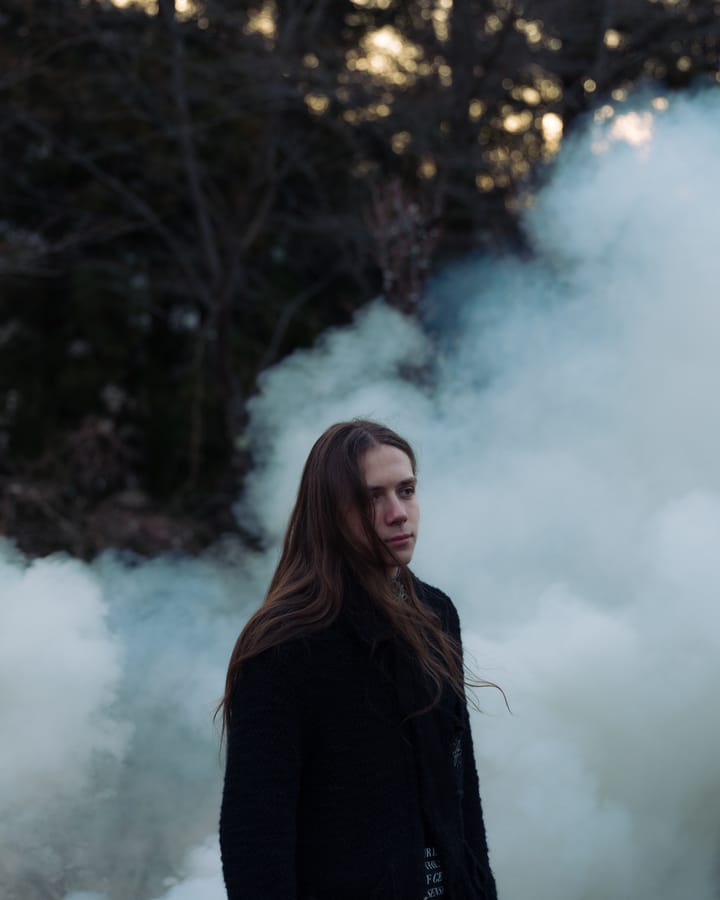 Portrait in drifting smoke at dusk