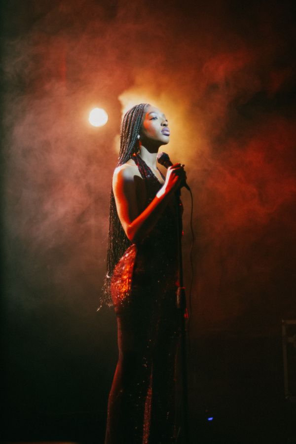 Singer on stage in red-lit haze