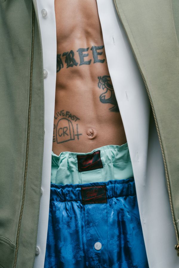 Tattooed torso and layered shirts