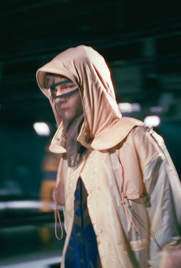 Hooded look in a concrete corridor