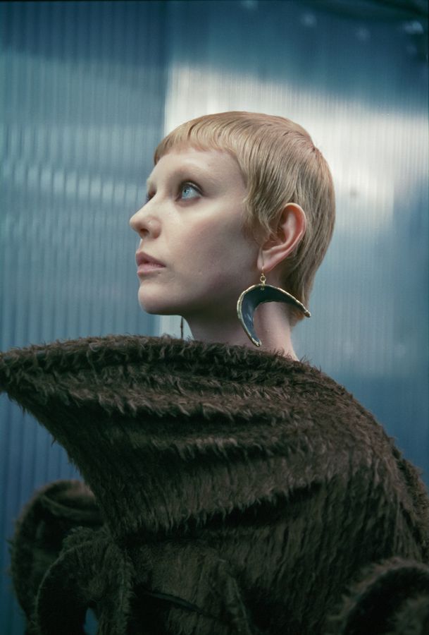 Model in sculpted knit looking up