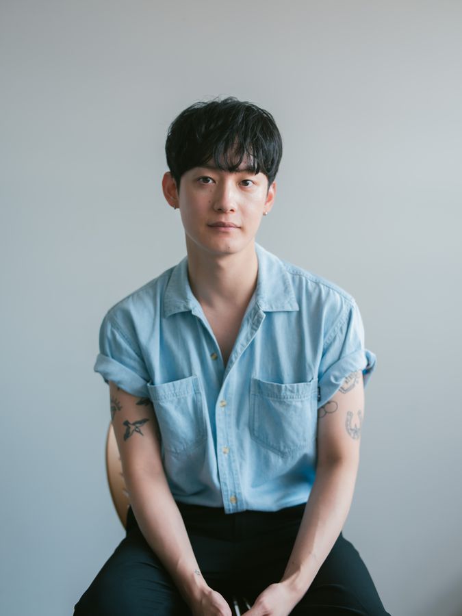 Seated studio portrait in a blue shirt