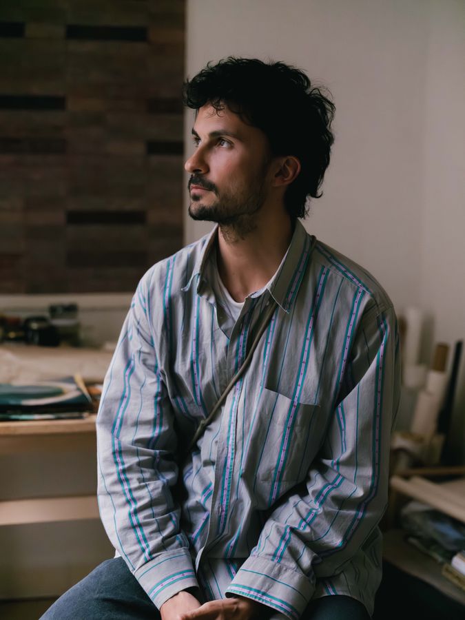 Artist seated in window light