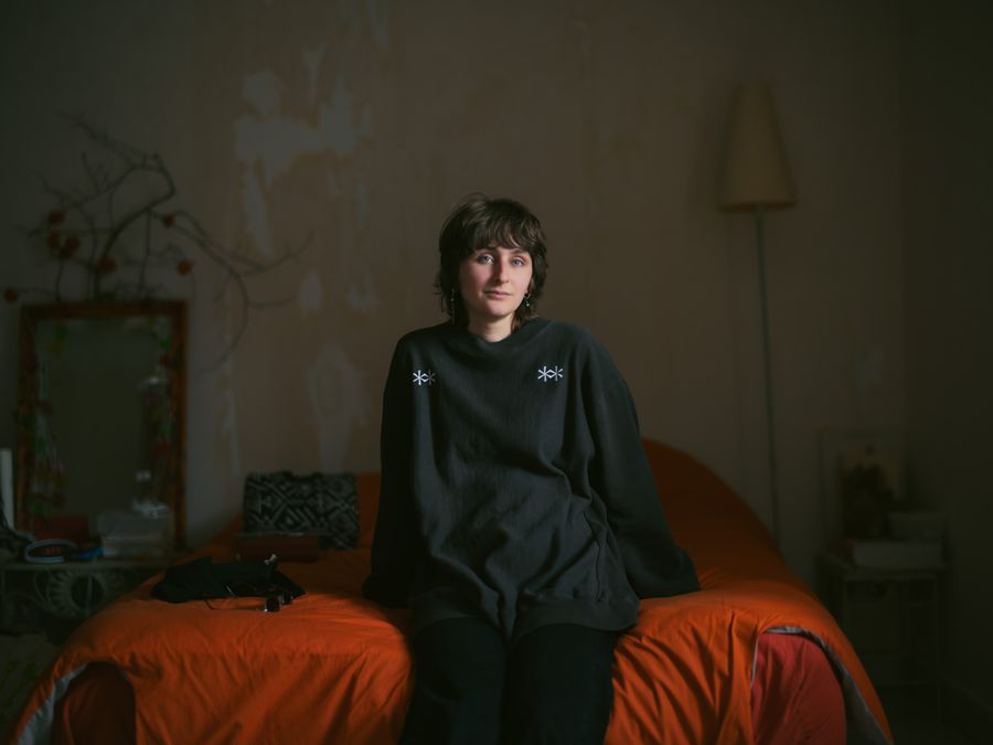 Seated on a bed in a quiet room