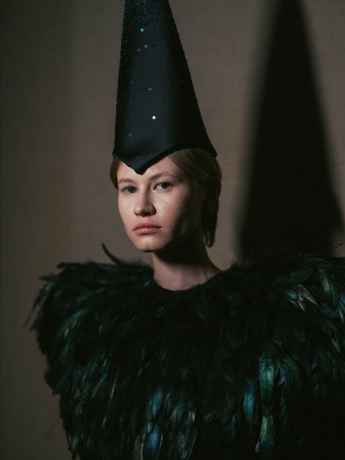 Feathered costume and pointed hat