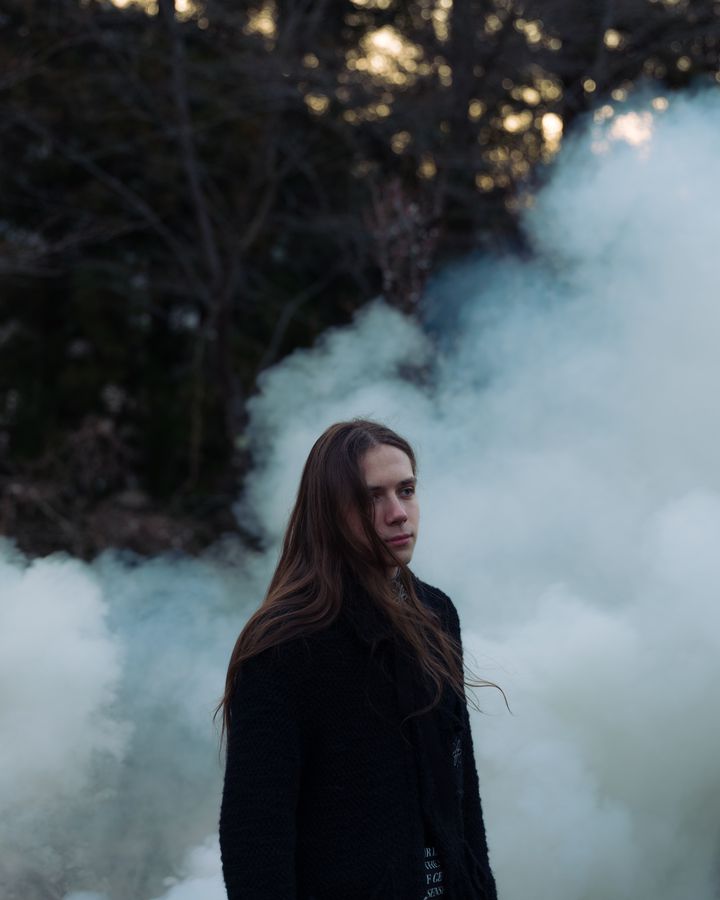 Portrait in drifting smoke at dusk