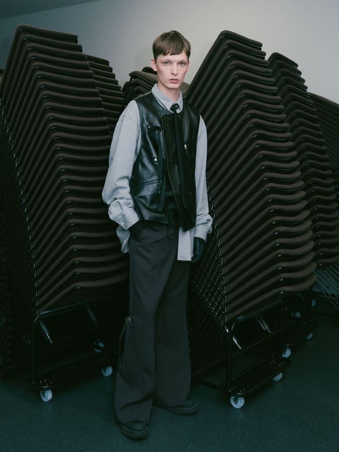 Model standing between stacked risers