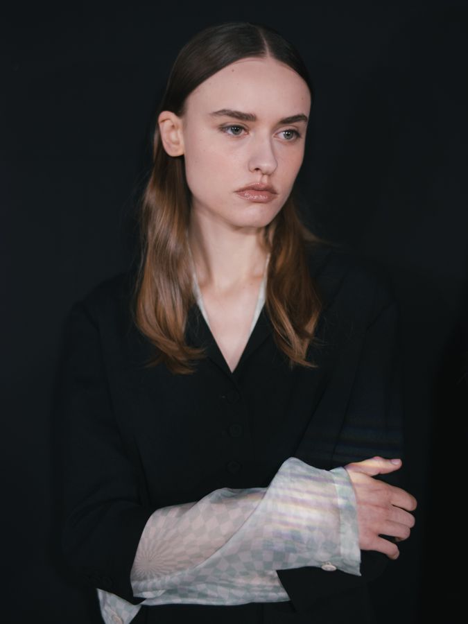 Portrait in black, arms crossed