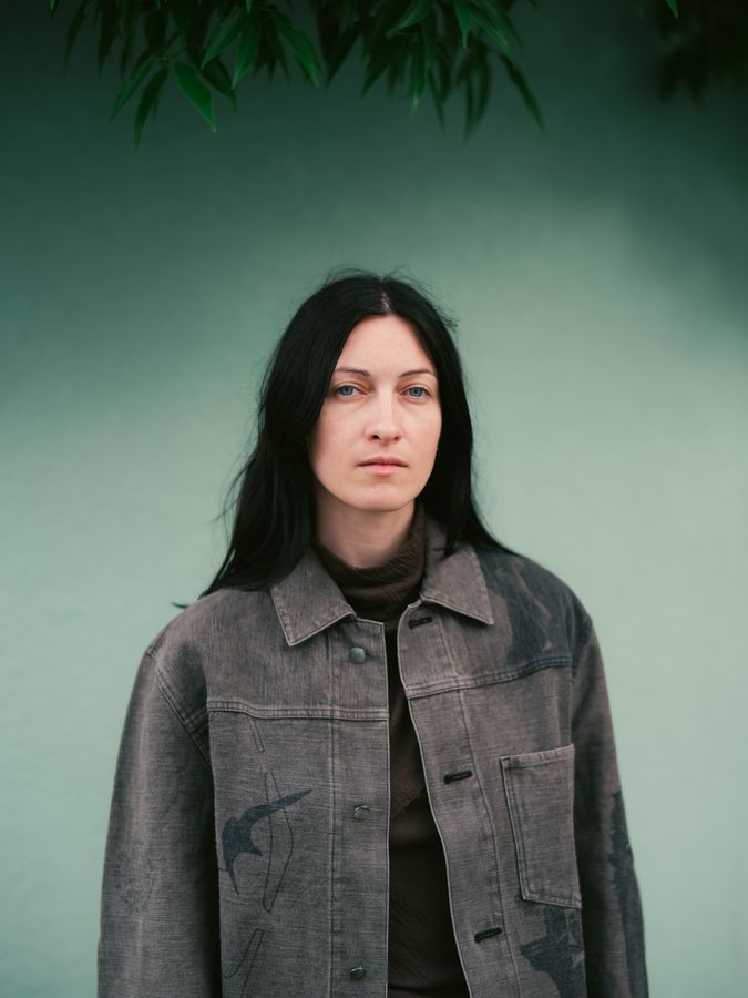 Portrait against a green wall