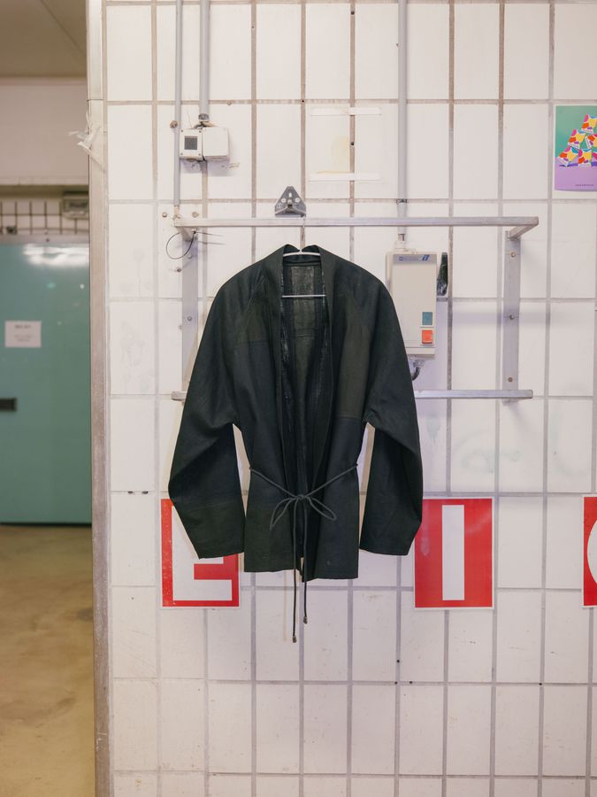 Jacket hanging on a tiled wall