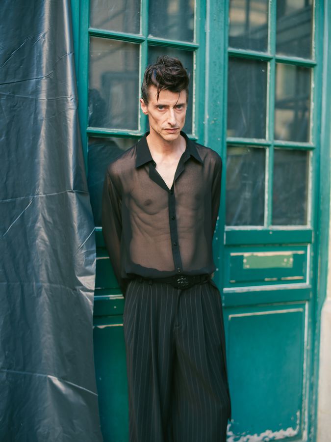 Sheer shirt against green doors